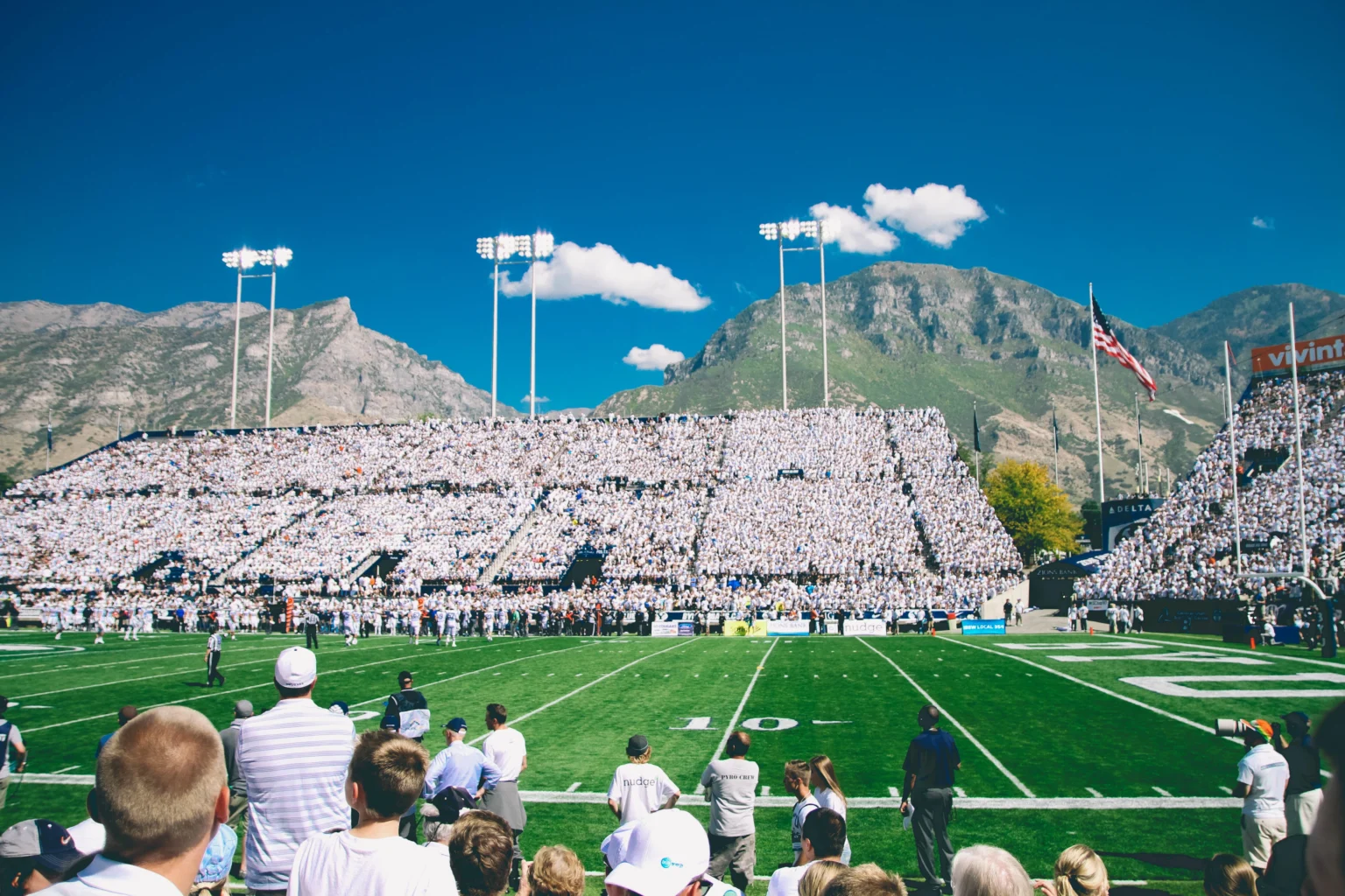 Football field with mountains and blue sky