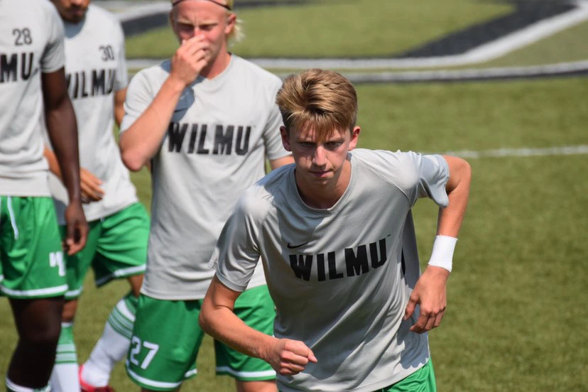 College soccer player running on field