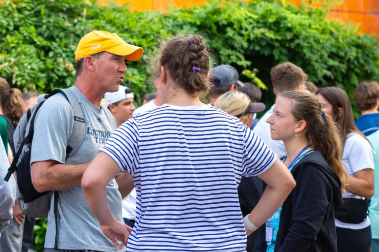 College tennis coach talking to players