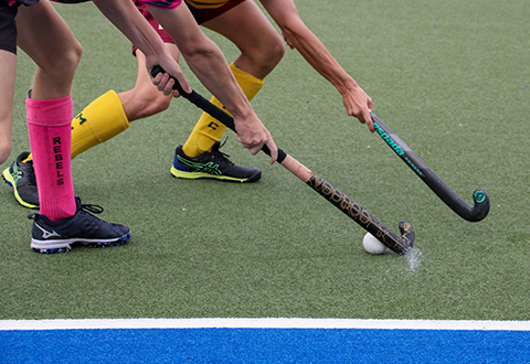 Close up of filed hockey players in action