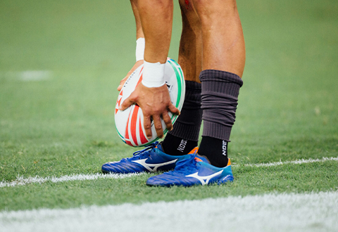 Rugby player's leg with rugby ball