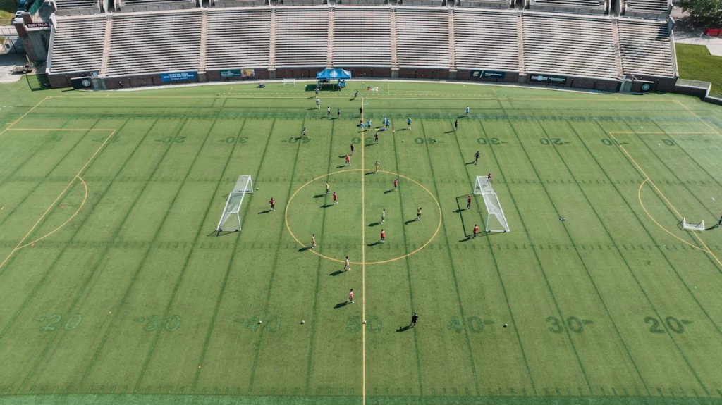 College soccer team training on the field during a preseason practice session