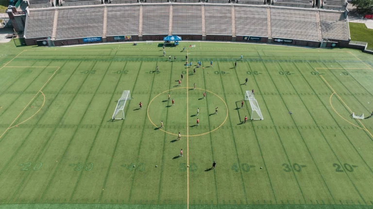 College soccer team training on the field during a preseason practice session