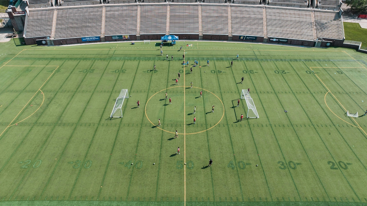 College soccer team training on the field during a preseason practice session