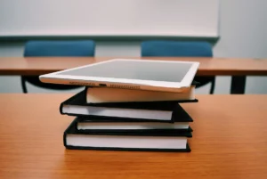 Notebooks and tablet on a table.