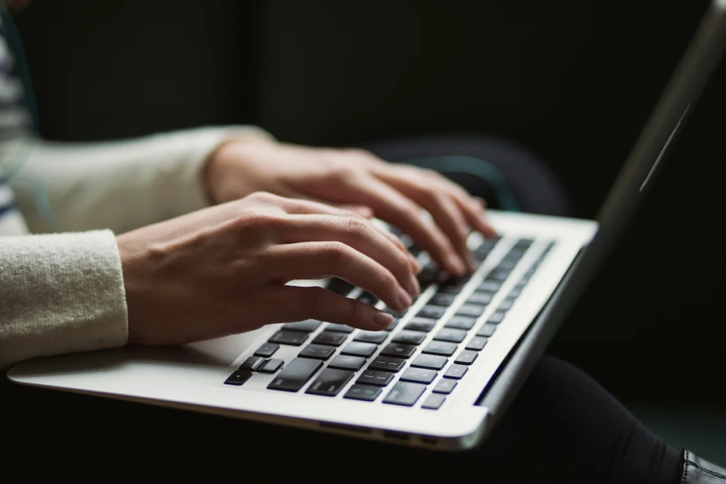 Student typing on her laptop.