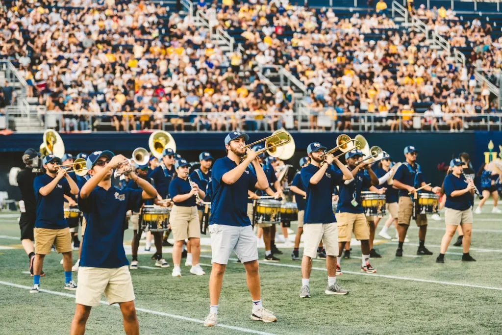 Student marching band performing during a college football halftime show