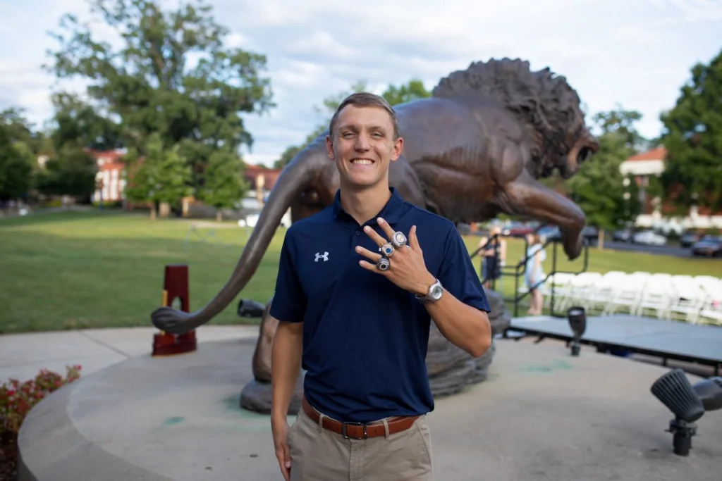 College swimmer Jan Delkeskamp showing his championship rings.