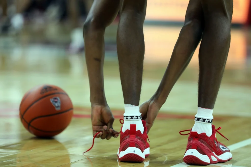 Basketball player tying his shoes