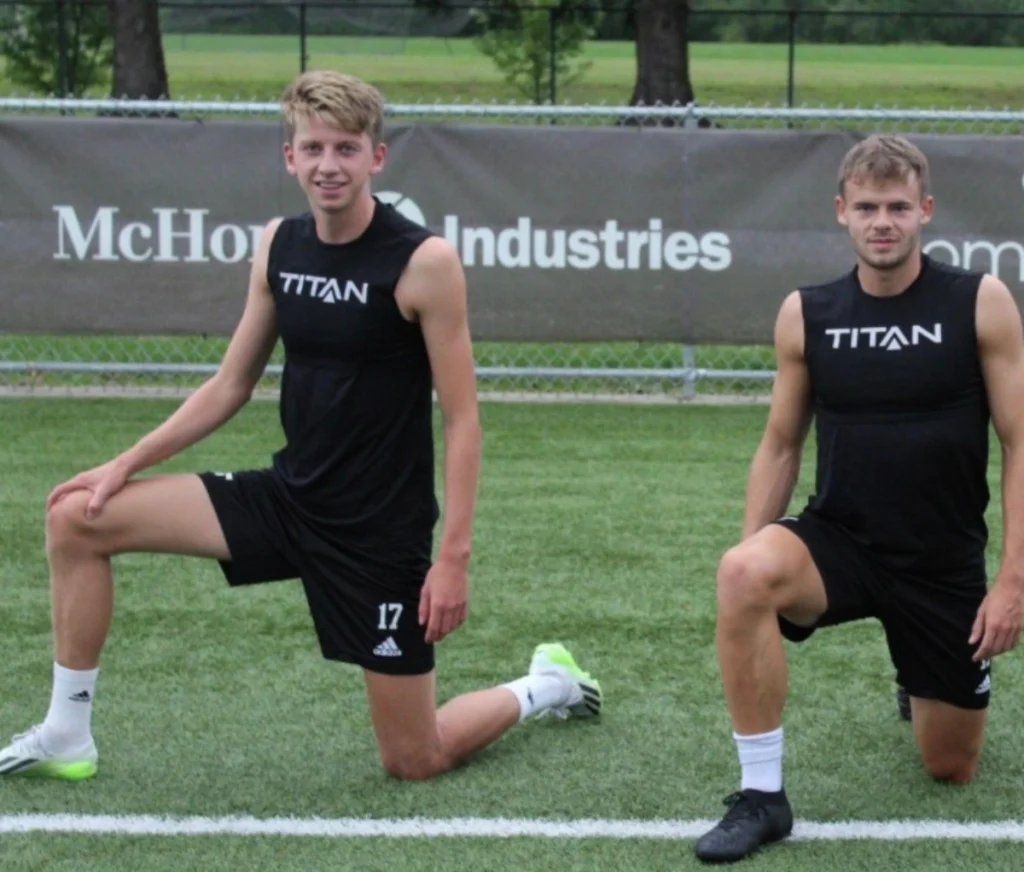 Daniel Helle and his teammate stretching after practice