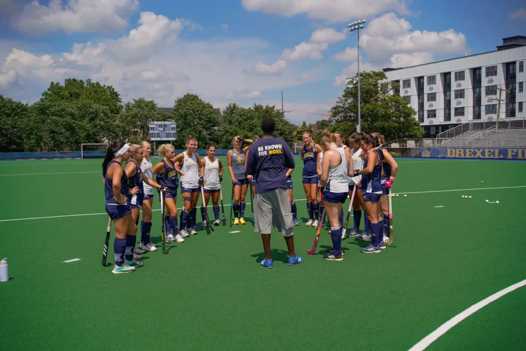 A group of hockey players with trainer