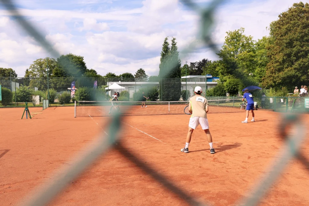photo of a tennis court with four players