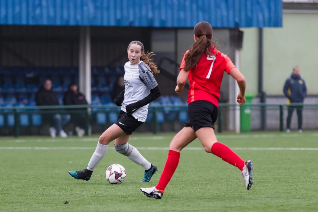 Two girls playing soccer