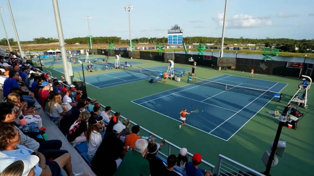 tennis courts from the ncaa with tennists playing.