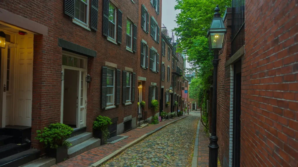Photo of a Boston street with a USA flag. Photo by Mike Bryant on Unsplash