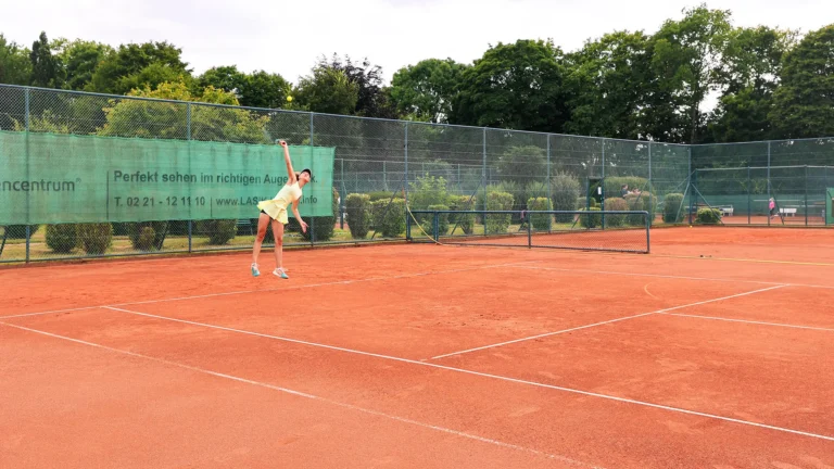 Jumping female tennis player at Keystone Sports College Tennis Showcase