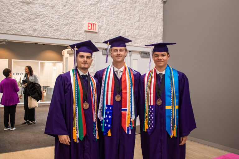 Håkon Torvbråten and two other Student Athletes wearing graduation gown
